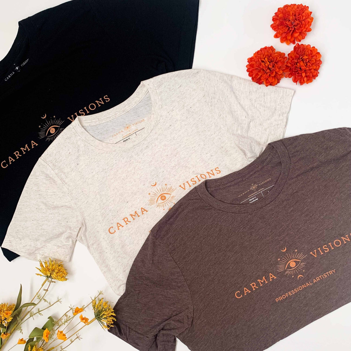 Carma Visions tri-blend t-shirts in three colors, styled flat lay