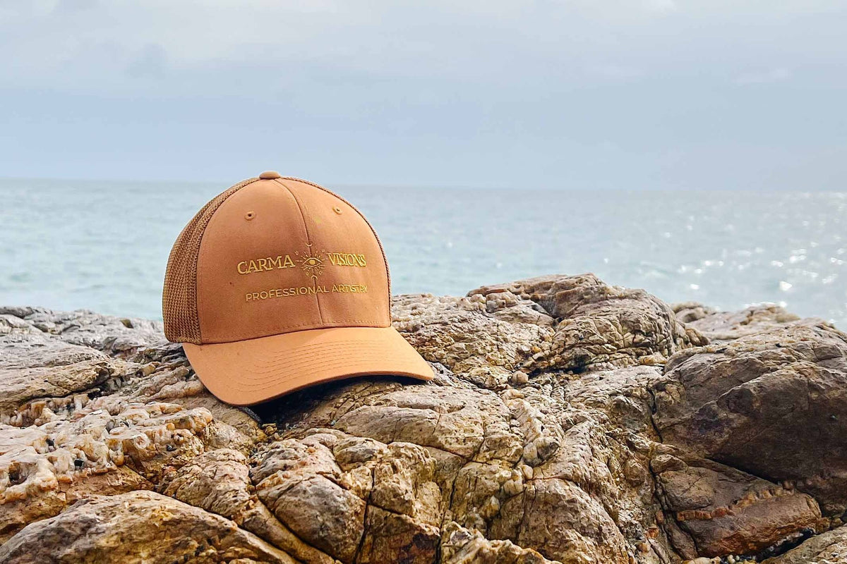 Carma Visions trucker cap in caramel on seaside rocks